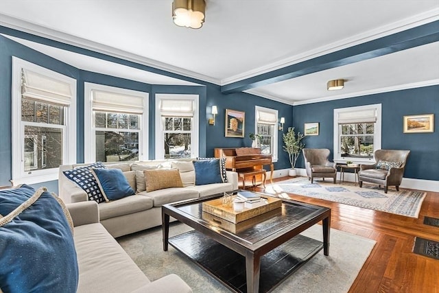 living area with crown molding, wood finished floors, and baseboards