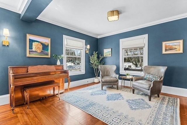 living area featuring baseboards, ornamental molding, and wood finished floors