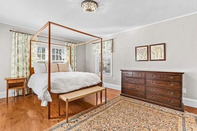 bedroom featuring wood finished floors and baseboards