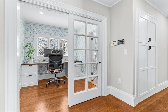 office area with baseboards, ornamental molding, wood finished floors, and wallpapered walls