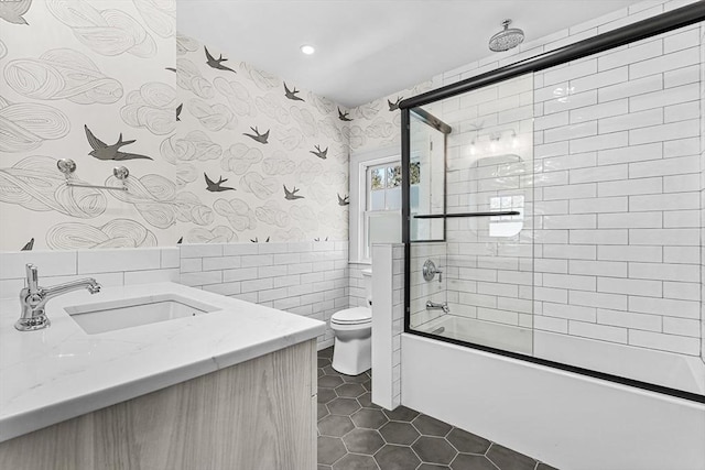 full bathroom with wallpapered walls, toilet, a combined bath / shower with rainfall shower, tile patterned floors, and tile walls