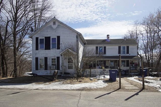 view of front of house featuring a porch and a chimney