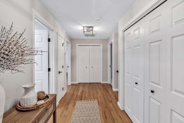 hallway with light wood-type flooring