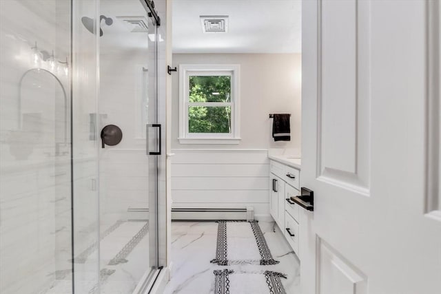 bathroom featuring an enclosed shower, vanity, and baseboard heating