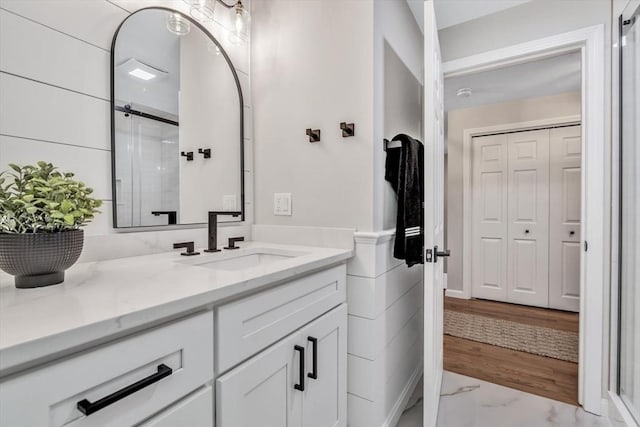 bathroom featuring vanity and a shower with shower door