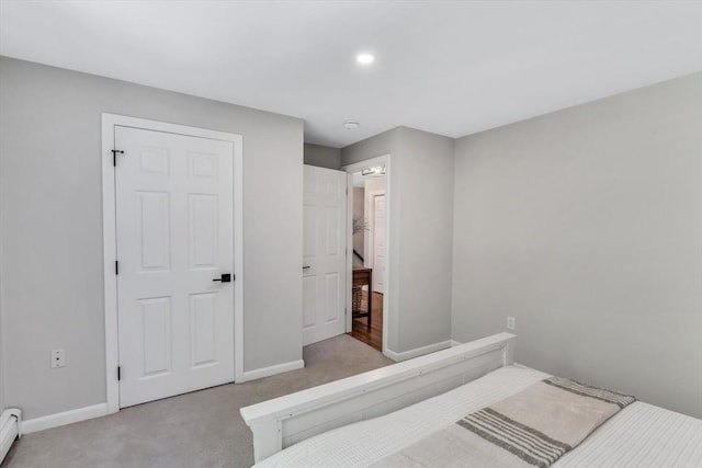 carpeted bedroom with a baseboard radiator