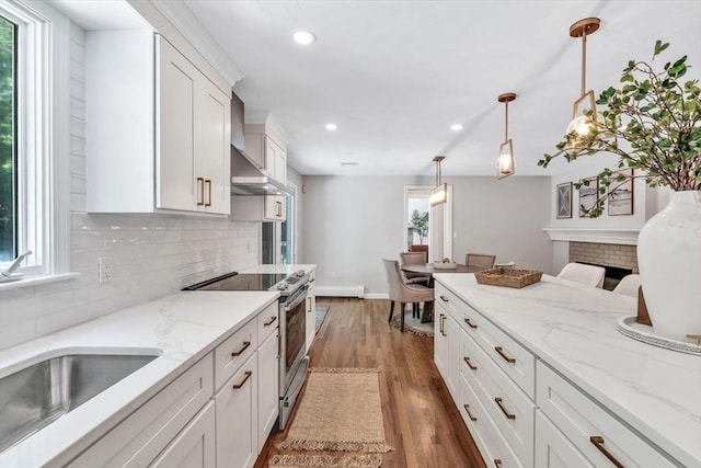 kitchen featuring white cabinetry, hanging light fixtures, wall chimney range hood, dark hardwood / wood-style floors, and stainless steel electric stove