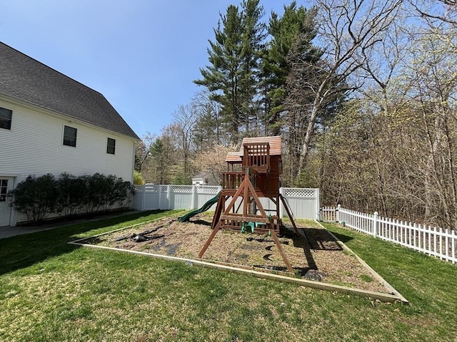 view of playground featuring fence and a yard