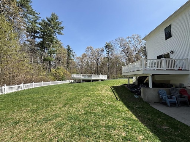 view of yard with a wooden deck and fence