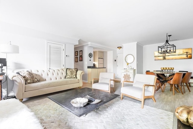 666 Main St Unit 206, Winchester, MA 01890 - living area with a chandelier, wood finished floors, and crown molding