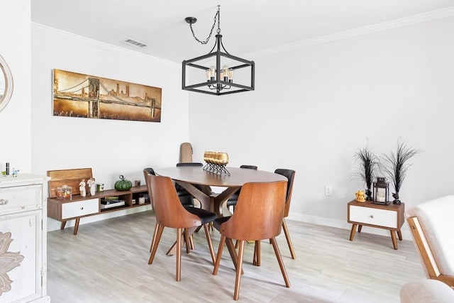 666 Main St Unit 206, Winchester, MA 01890 - dining area with a chandelier, light wood-style flooring, ornamental molding, and baseboards
