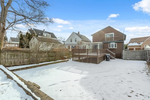 yard layered in snow featuring a wooden deck