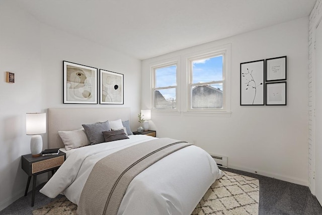 bedroom featuring carpet and a baseboard heating unit