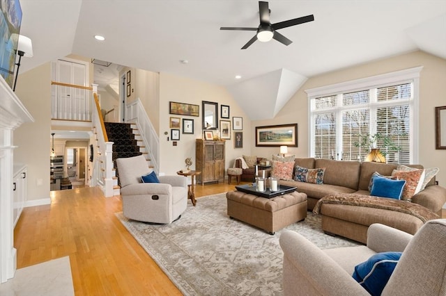 living room with stairway, light wood-type flooring, lofted ceiling, recessed lighting, and a ceiling fan