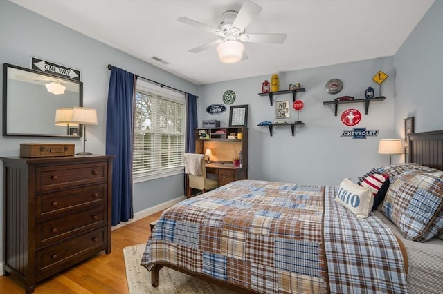 bedroom with a ceiling fan, baseboards, visible vents, and light wood-type flooring