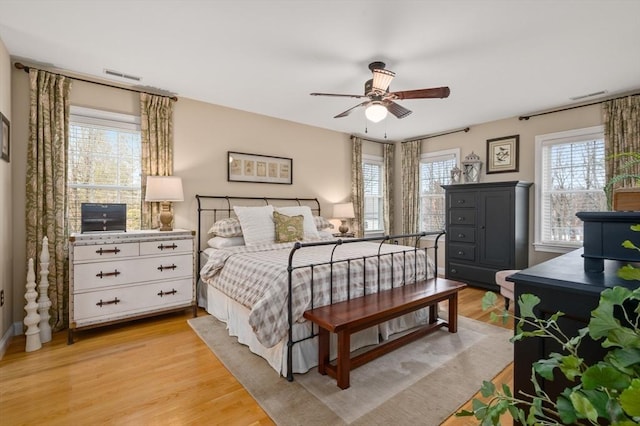 bedroom with light wood-style flooring and visible vents