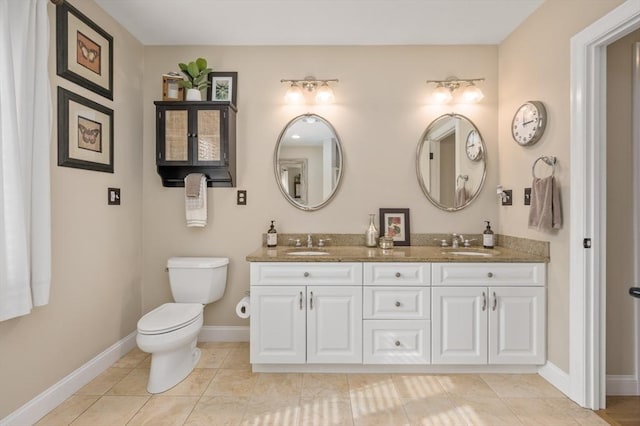 bathroom featuring tile patterned floors, toilet, baseboards, and a sink