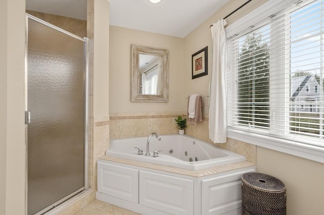 bathroom with tile patterned flooring, a shower stall, and a jetted tub