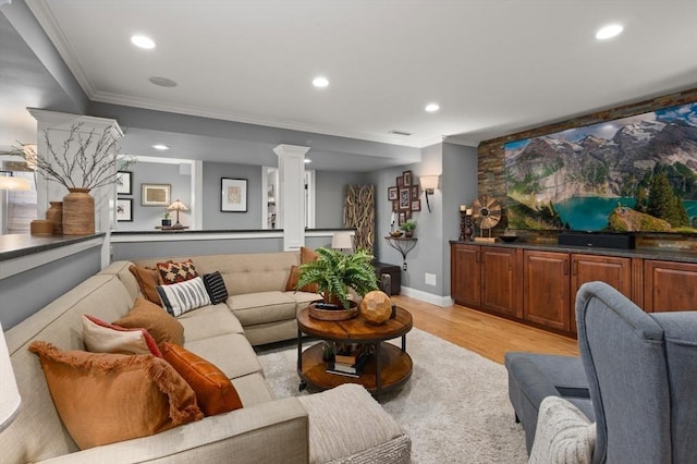 living area featuring light wood-style flooring, recessed lighting, visible vents, and ornamental molding