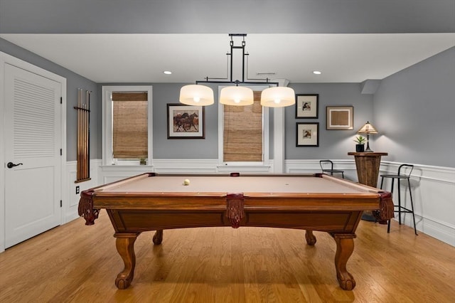 playroom featuring billiards, light wood-style floors, and a wainscoted wall