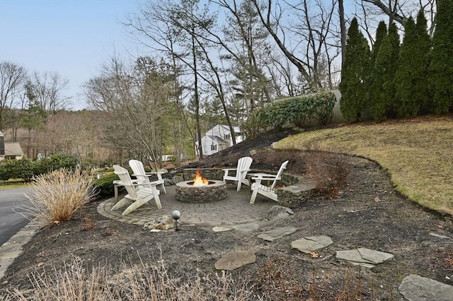 view of yard featuring a patio and an outdoor fire pit