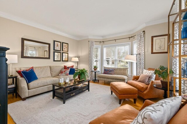 living room with ornamental molding and wood finished floors