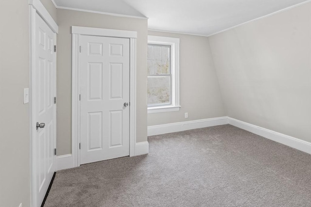 unfurnished bedroom with crown molding, baseboards, and carpet