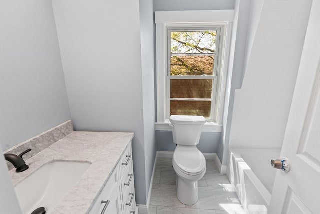 full bathroom with vanity, baseboards, and toilet