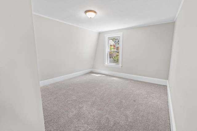 unfurnished room with baseboards, carpet, and crown molding