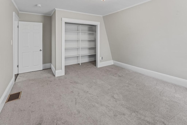 unfurnished bedroom featuring carpet floors, visible vents, and ornamental molding