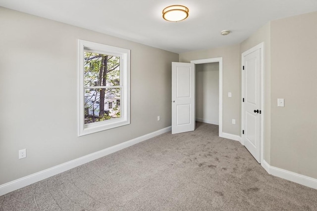 unfurnished bedroom featuring baseboards and carpet