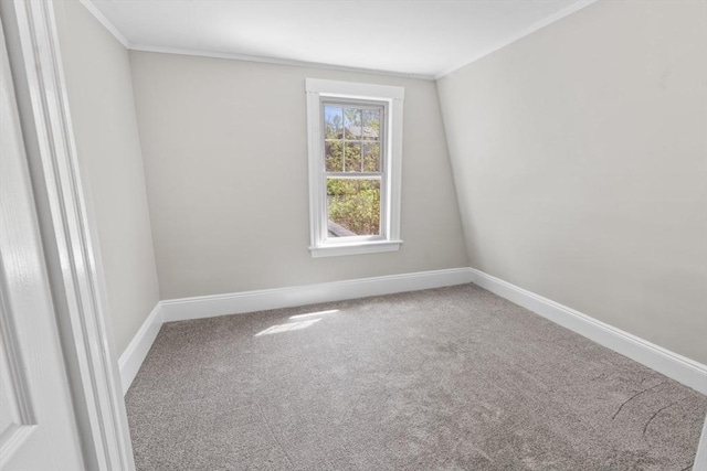 carpeted empty room featuring baseboards and ornamental molding