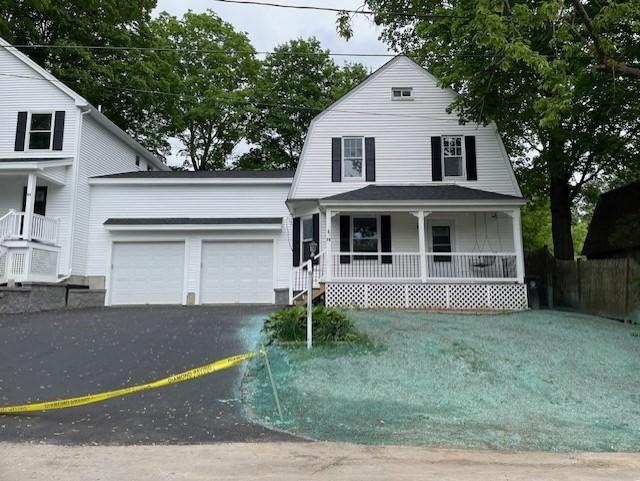 76 15th Ave Unit 2, Haverhill, MA 01830 - view of front of home featuring a porch, a gambrel roof, an attached garage, driveway, and a front lawn