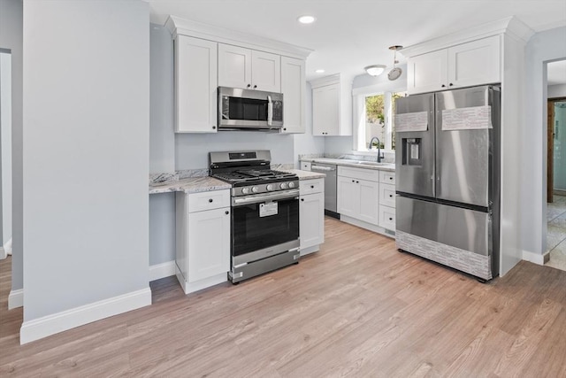 kitchen with white cabinetry, baseboards, and appliances with stainless steel finishes