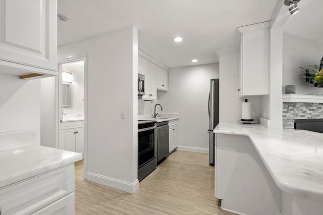 kitchen featuring stainless steel appliances, white cabinetry, light wood finished floors, recessed lighting, and baseboards