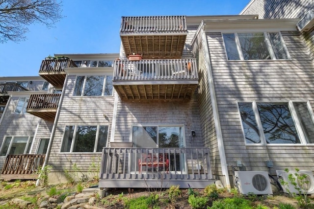 rear view of house with a balcony and a cooling unit
