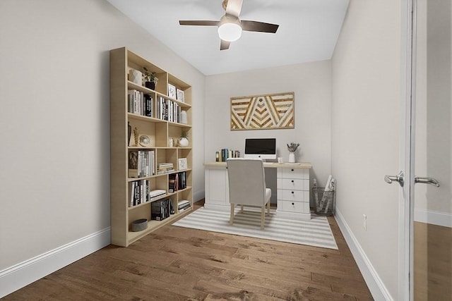 office space with a ceiling fan, wood finished floors, and baseboards