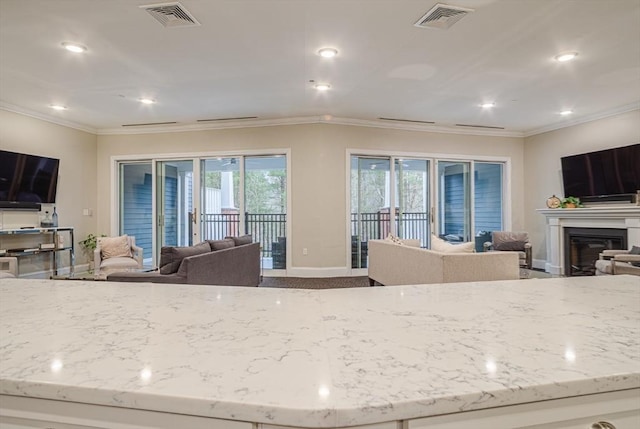 kitchen featuring light stone counters, open floor plan, and visible vents