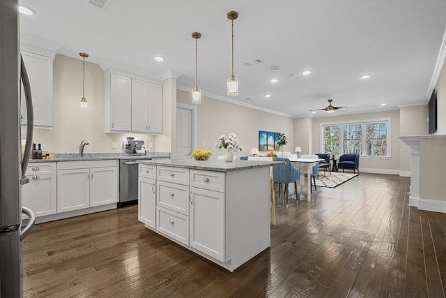 kitchen with recessed lighting, ornamental molding, ceiling fan, and appliances with stainless steel finishes