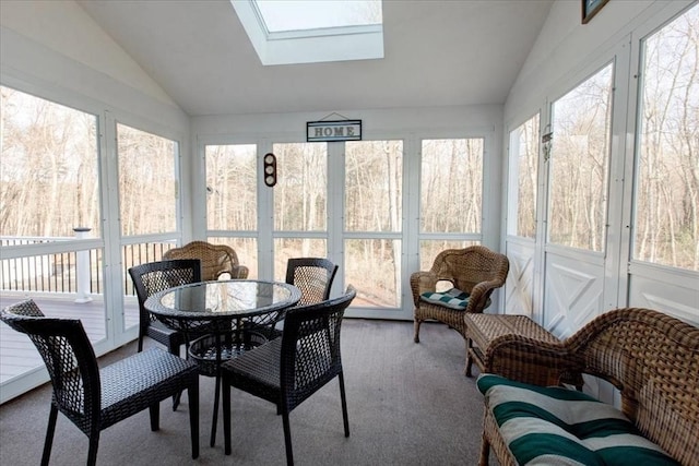 sunroom featuring lofted ceiling with skylight