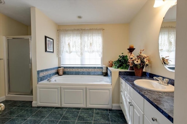 bathroom featuring tile patterned floors, a garden tub, vanity, and a shower stall