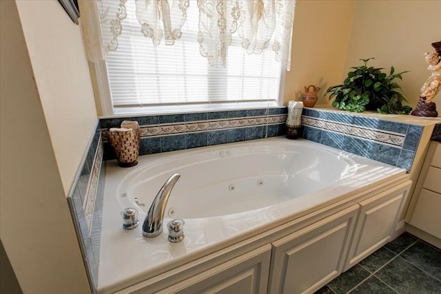 full bathroom with tile patterned floors and a tub with jets