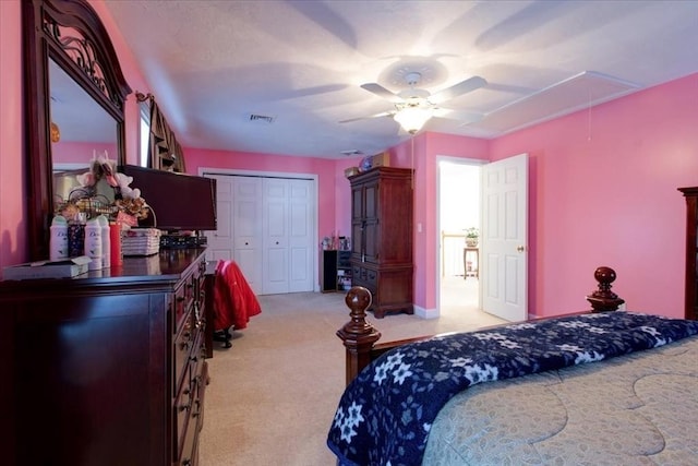 bedroom featuring visible vents, ceiling fan, attic access, carpet flooring, and a closet