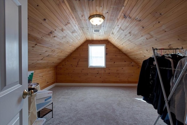 bonus room featuring visible vents, lofted ceiling, wooden walls, and wooden ceiling