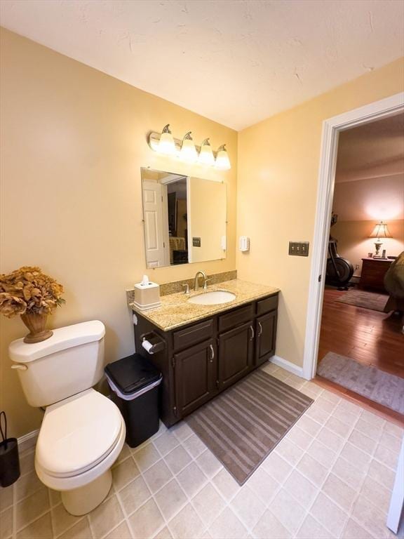 93 Mccracken Rd, Millbury, MA 01527 - bathroom with toilet, vanity, and tile patterned floors