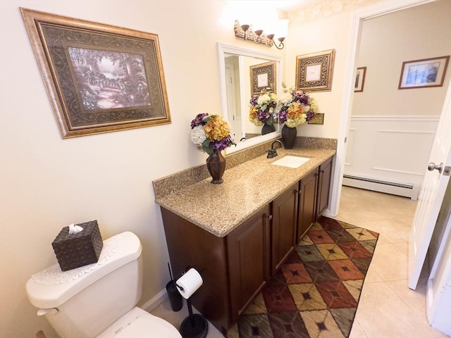 93 Mccracken Rd, Millbury, MA 01527 - bathroom featuring a baseboard heating unit, vanity, toilet, and tile patterned flooring
