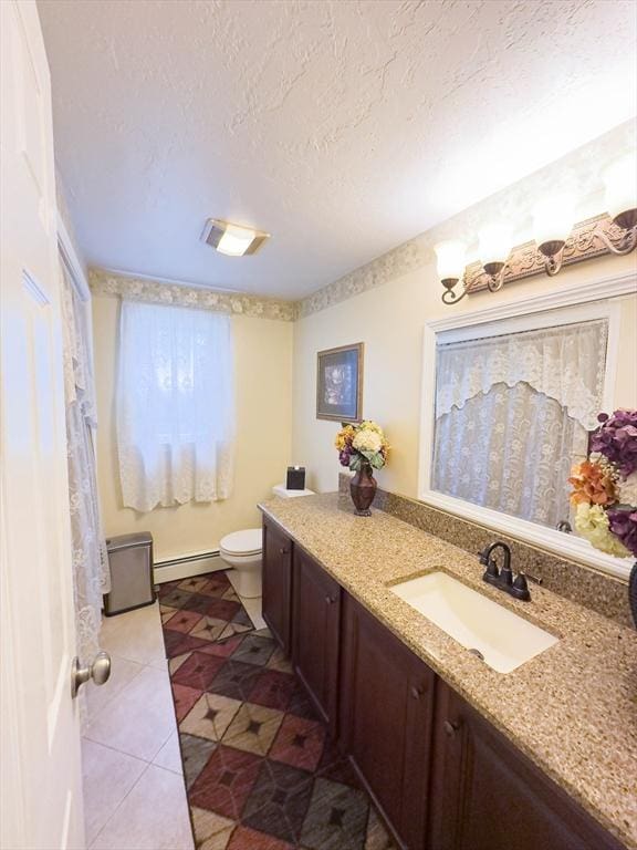 93 Mccracken Rd, Millbury, MA 01527 - bathroom featuring baseboard heating, vanity, toilet, tile patterned floors, and a textured ceiling