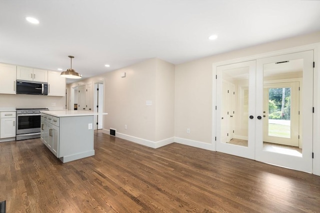 47 Jacob St, Seekonk, MA 02769 - kitchen with stainless steel appliances, light countertops, recessed lighting, dark wood finished floors, and a kitchen island