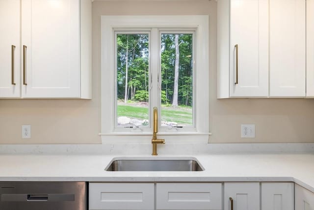 47 Jacob St, Seekonk, MA 02769 - kitchen with a sink, dishwashing machine, white cabinetry, and light stone counters