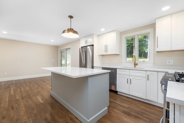 47 Jacob St, Seekonk, MA 02769 - kitchen with stainless steel appliances, a sink, light countertops, dark wood finished floors, and white cabinets